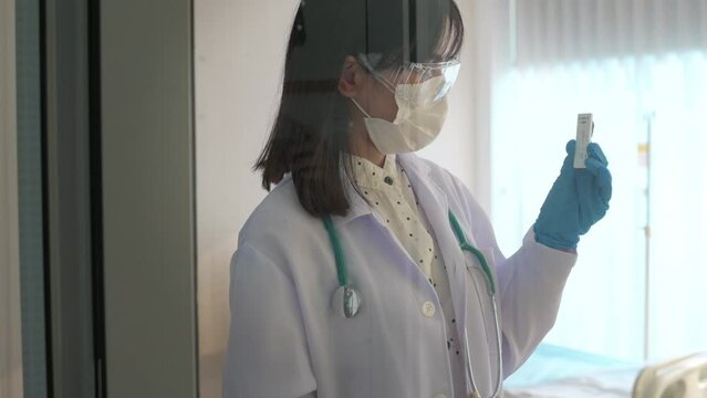 Young female doctor holding ATK kit in hospital, covid19 and pandemic concept
