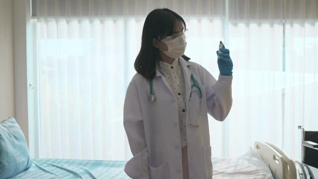 Young female doctor holding ATK kit in hospital, covid19 and pandemic concept