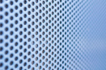 macro photo of perforated metal surface with selective focus