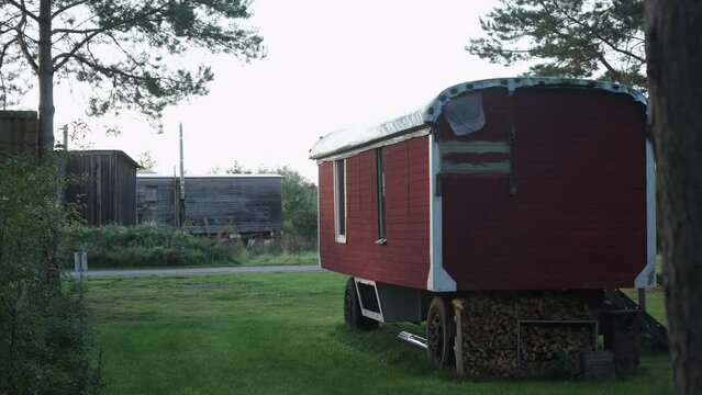 View Of Parked Wooden Caravan At Sieben Linden Ecovillage, tinyhouse and sustainable living in nature concept
