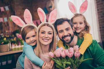 Photo of cute lovely family with bunny ears celebrate easter holiday father hold present for mother...