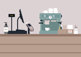 A coffeeshop counter with a register and a pos terminal, a coffee machine with cups on top of it, a hand sanitizer bottle, a sugar dispenser and a stack of napkins