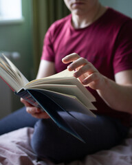 man turns the pages of a book