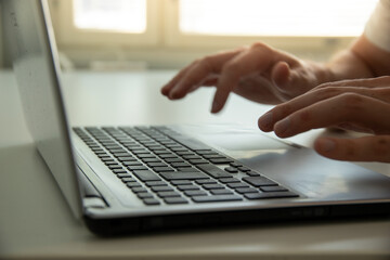close up of person typing on a laptop keyboard