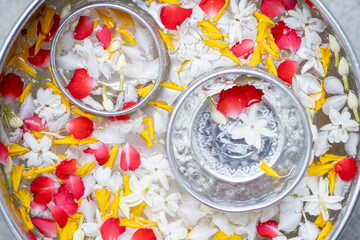 Water with jasmine and roses corolla in bowl for Songkran festival in Thailand.