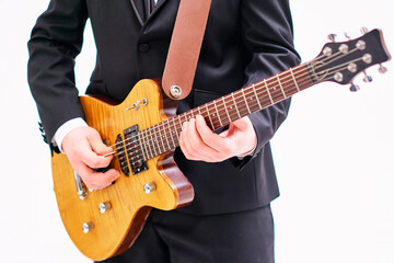 Fototapeta na wymiar Close up of young man playing electric guitar on white background.