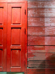 Red wooden window.There are pale marks on the wall.