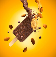 Almond ice cream stick, almonds around, yellow background