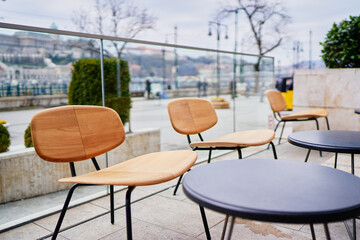 The wooden chairs in sidewalk cafe.