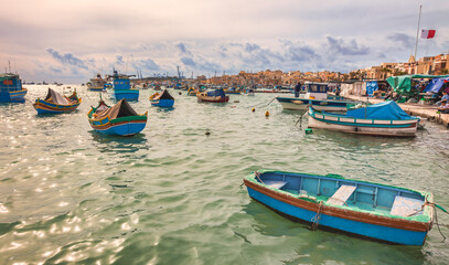 Obraz premium Marsaxlokk harbor with multicoloured boats Malta