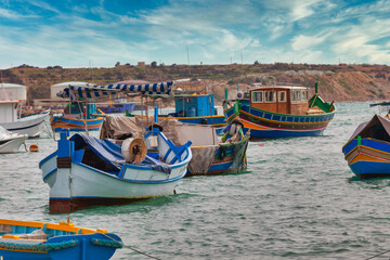 Fototapeta na wymiar Marsaxlokk harbor with multicoloured boats Malta
