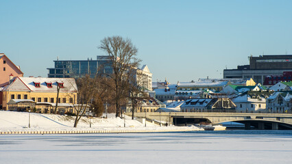 Neighborhood of old houses and modern buildings in winter. Retro versus modern style. Contrast in architecture.