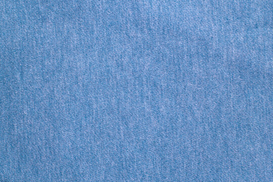 Blue knitted fabric cotton textured background. Closeup with copy space for your design