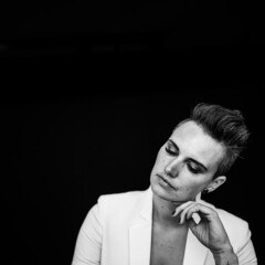 Woman headshots in a white suit black and white 