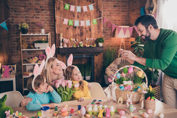 Photo of good mood family spend holiday weekend indoors daddy take picture of his family give mom flowers prepare easter holiday party