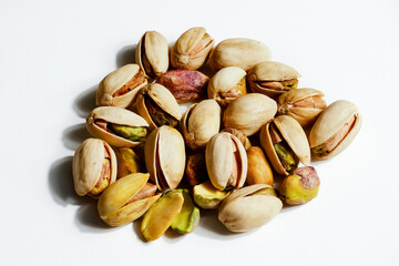 Peeled roasted pistachios isolated on white background