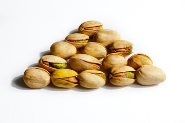 Peeled roasted pistachios isolated on white background