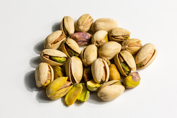 Peeled roasted pistachios isolated on white background
