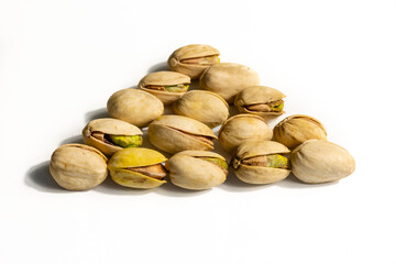 Peeled roasted pistachios isolated on white background