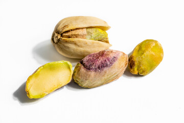 Peeled roasted pistachios isolated on white background