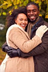 Portrait Of Loving Couple On Walk Through Autumn Countryside Together