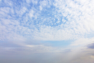 Blue sky background with white cirrus clouds