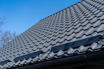 roof under construction with stacks of roof tiles for home building
