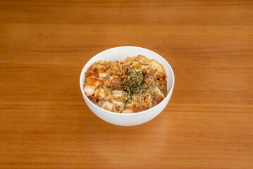 Oyakodon, is a Japanese donburi or rice ball made with chicken, egg, spring onion, and other ingredients simmered in a sauce, then served over a large bowl of rice.