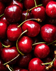 Fresh raw cherry background. Close up of bright red cherries with drops of water. Vitamin rich berries. Macro food texture