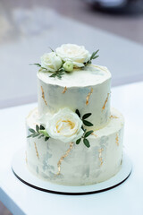 Wedding designer cake with roses to be eaten by newlyweds and wedding guests