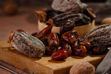 Dried fruits and walnuts on a brown board. Dried persimmon and dried dates