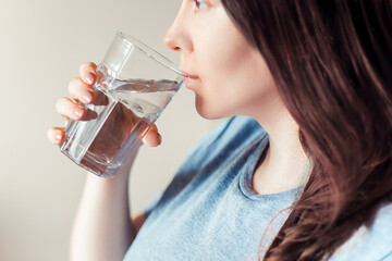 Woman drinks clean water. World Water Day. Health care concept. Diet and detox, increase metabolism.