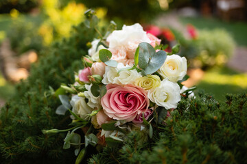 Beautiful wedding bouquet of the bride of roses. Ukrainian couple getting married. Summer weather and lots of bright green background