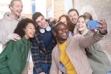Multiracial young people group taking selfie with a smartphone - Happy lifestyle concept with young...