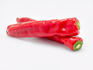 Two red peppers on a white background - 497095200