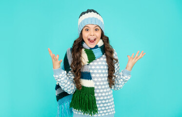 winter fashion. surprised emotional kid with curly hair in hat and scarf. teen girl