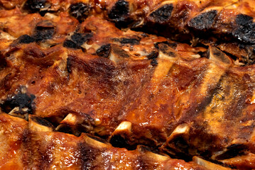 Obraz na płótnie Canvas Fried ribs on a metal pan in fat. Meat products from beef