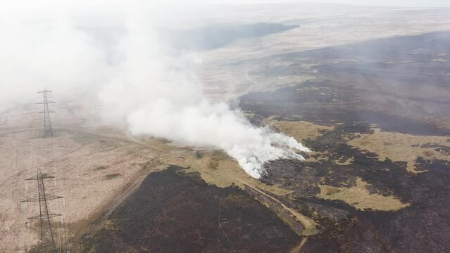 Aerial view of firefighters attempting to control a large grassfire