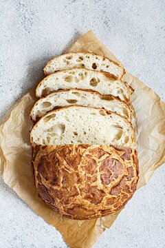 Fresh crispy Tiger (Dutch) bread with a delicious beautiful crust and wonderful homemade taste on a light background. Bakery product with cracks.