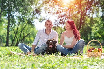 Couple with a dog in the park