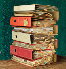 stack of messy file folders,red tape, bureaucracy, administration or business concept