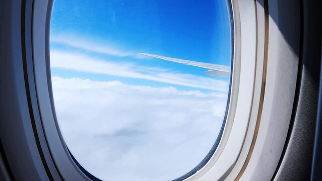 View from plane window. Plane window view during flight. Airplane wing. Looking through plane window. Travel concept. Sky From The Plane Window. 