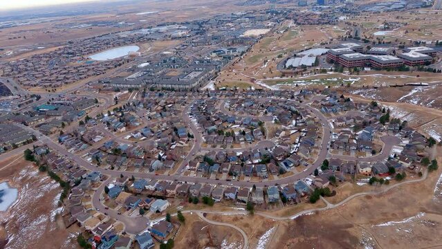 Aerial view looking down as an airplane turns to land at the Rocky Mountain Metropolitan Airport
