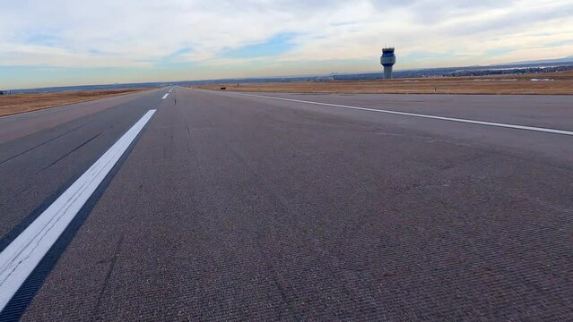 Airplane view of the runway, control tower and water towers at the Rocky Mountain Metropolitan Airport.