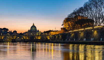 Fototapeta na wymiar St. Angelo Bridge, Castel Sant'Angelo and St. Peter's Basilica at Sunset