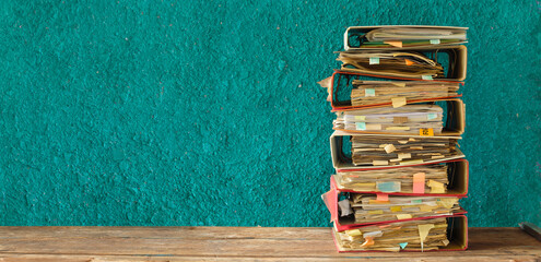 stack of messy file folders,red tape, bureaucracy,aministration,business concept. Large free copy space, negative space technique. - obrazy, fototapety, plakaty