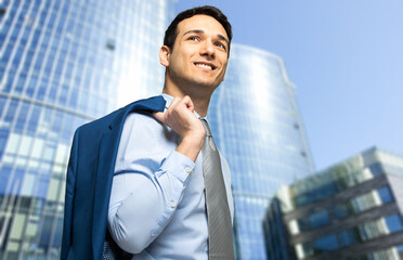 Fototapeta premium Businessman walking outdoor holding his jacket