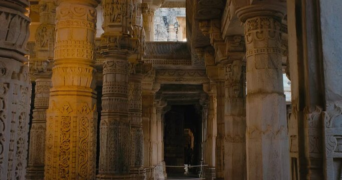 Columns of beautiful Ranakpur Jain temple or Chaturmukha Dharana Vihara. Marble ancient medieval carved sculpture carvings of sacred religious place of jainism worship. Ranakpur, Rajasthan. India