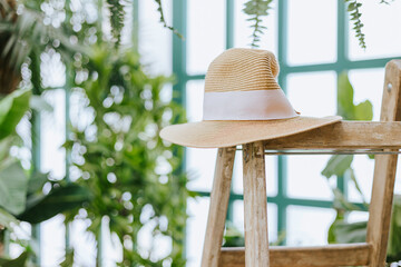 greenhouse or a terrace for rest and relaxation, blooming garden, sun hat summer style