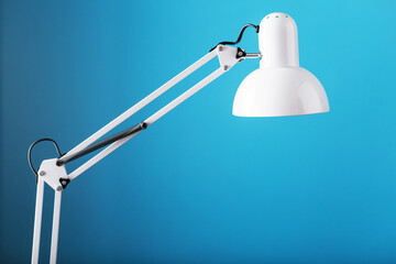 Office table lamp on blue background with space for text and idea concept